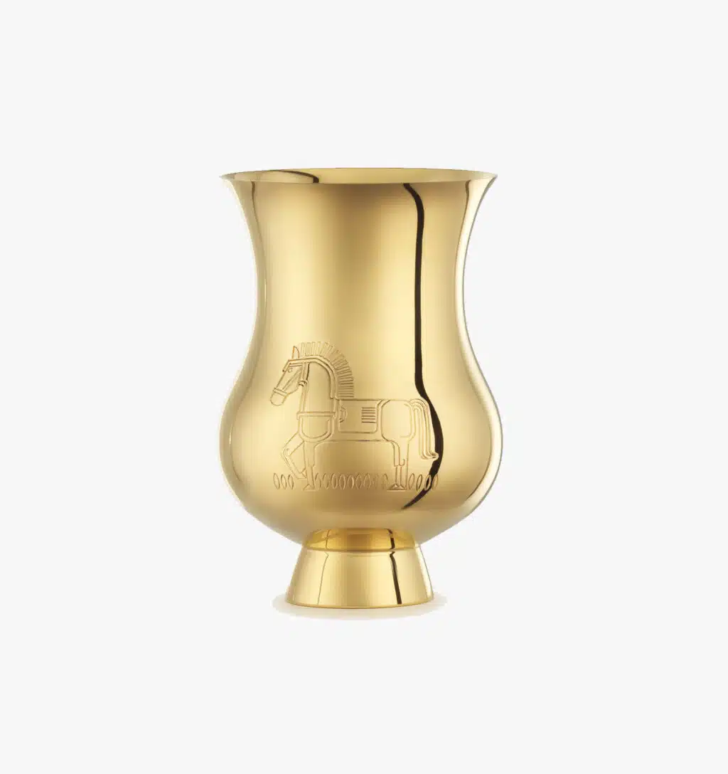 Tumbler engraved with the zodiac sign of the "Year of the Horse" in vermeil from the Pour le champagne collection by Puiforcat on a light background.