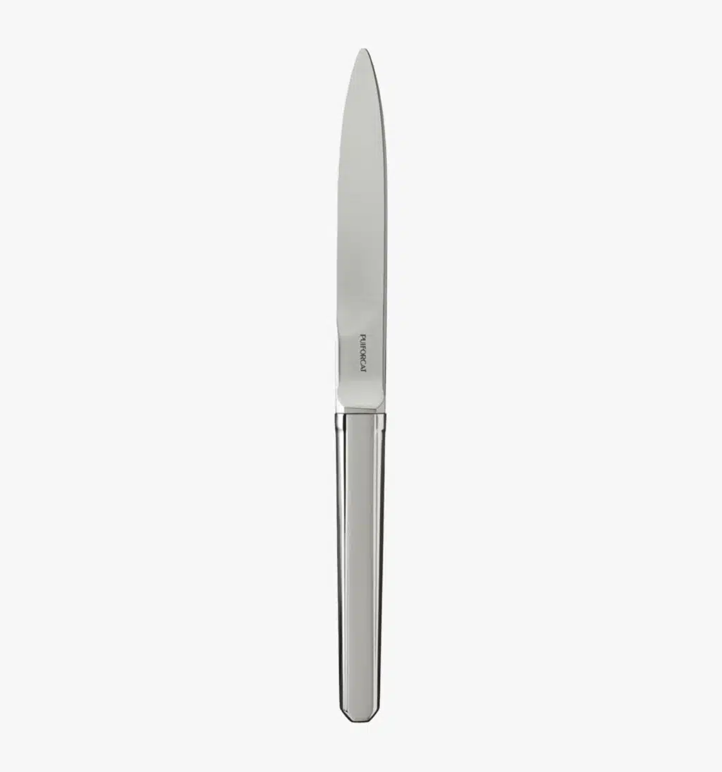 Solid steel table knife from the Guéthary collection by Puiforcat on a light background