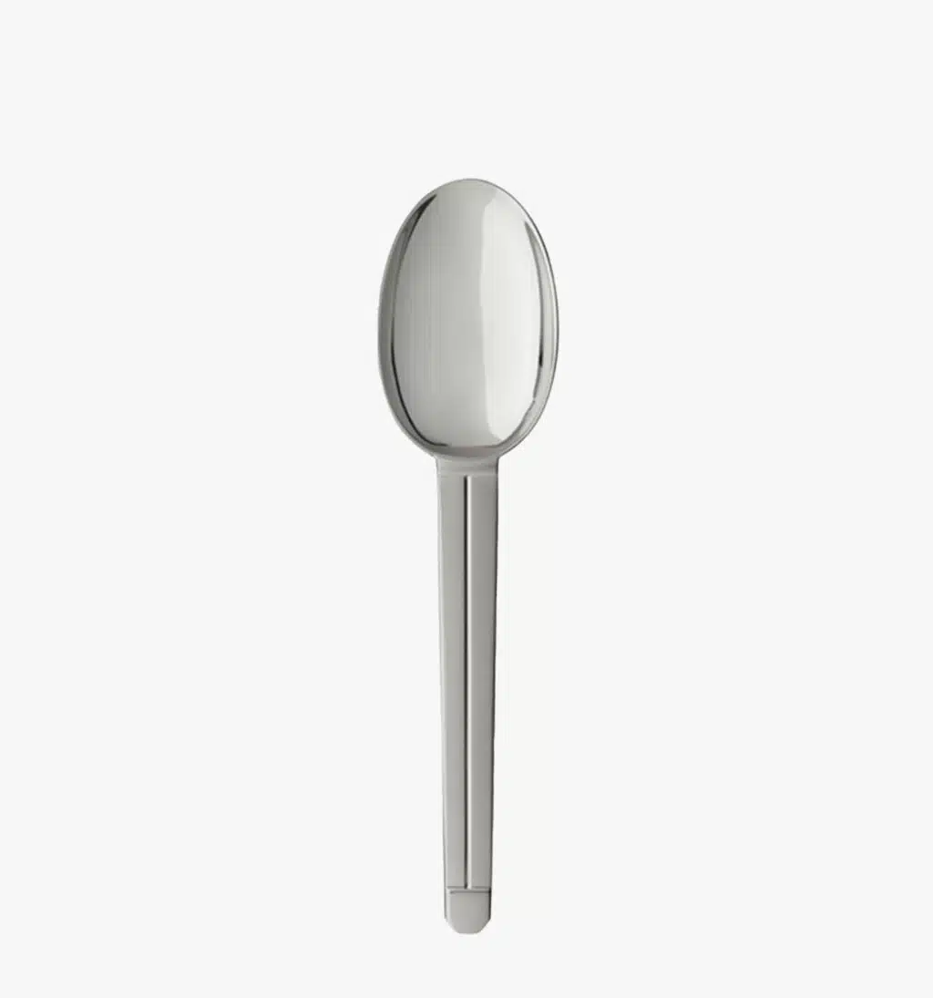 Stainless steel table spoon from the Guéthary collection by Puiforcat on a light background