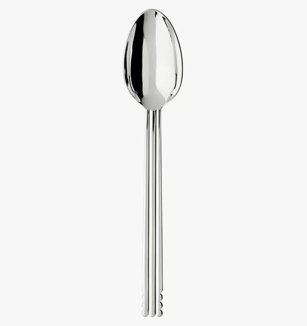 Silver plated serving spoon from the Nantes collection by Puiforcat on a light background.