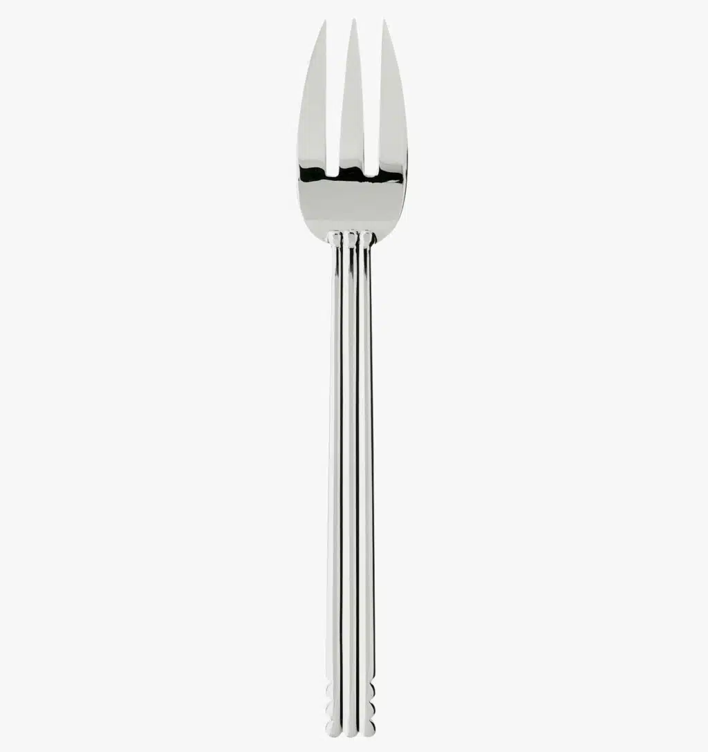 Silver plated serving fork from the Nantes collection by Puiforcat on a light background.