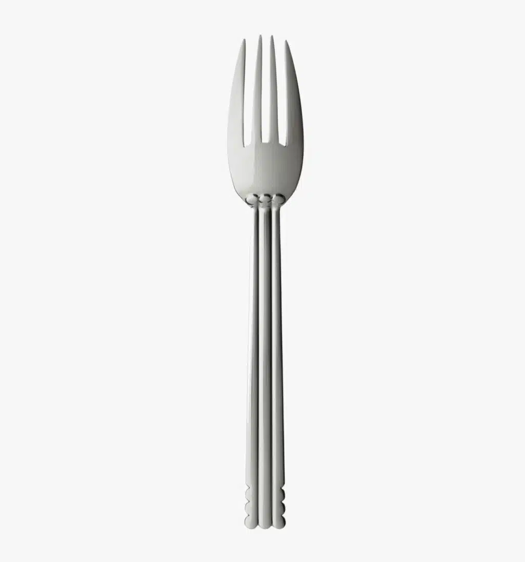 Silver plated table fork from the Nantes collection by Puiforcat on a light background.